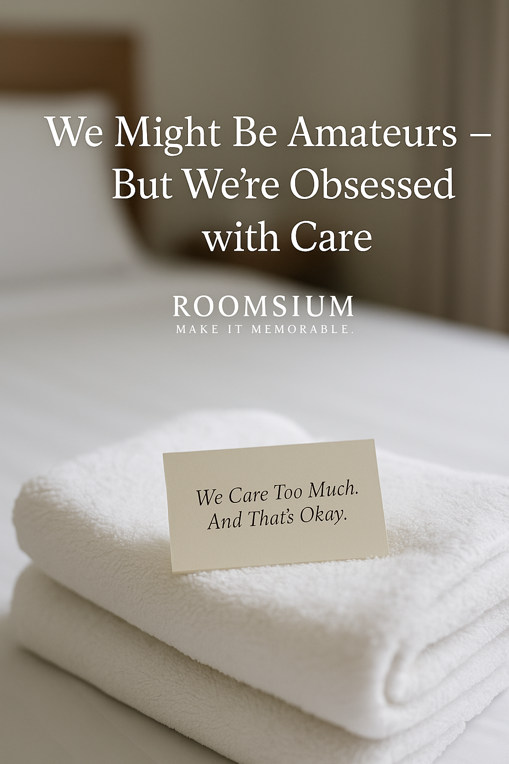 neatly folded white towels on a made bed with a cream colored note reading we care too much and thats okay roomsium logo and slogan make it memorable in the background